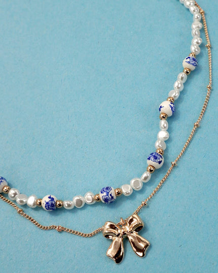 CERAMIC PORCELAIN PEARL BOW LAYER NECKLACE | 80N91555