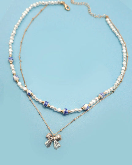 CERAMIC PORCELAIN PEARL BOW LAYER NECKLACE | 80N91555