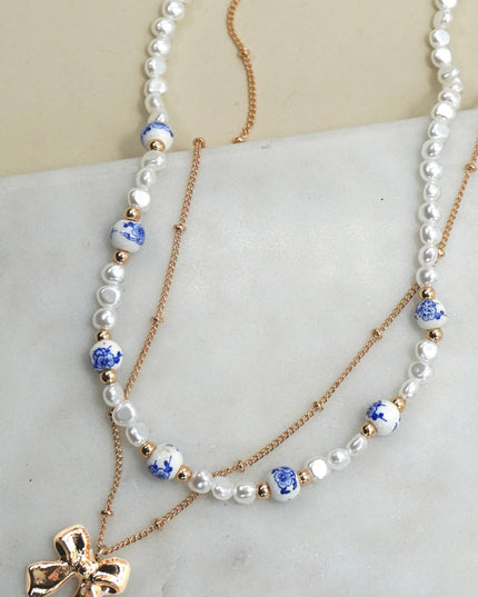 CERAMIC PORCELAIN PEARL BOW LAYER NECKLACE | 80N91555